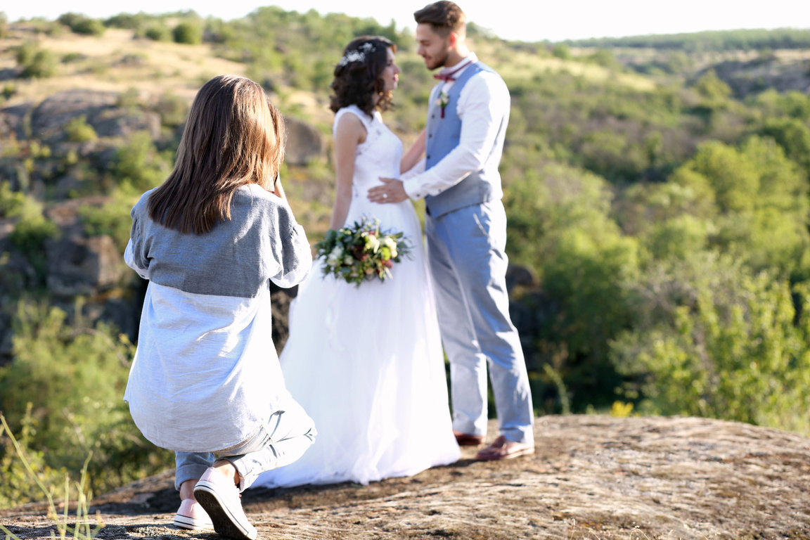 Wedding Photographer Taking Photo of Bride and Groom